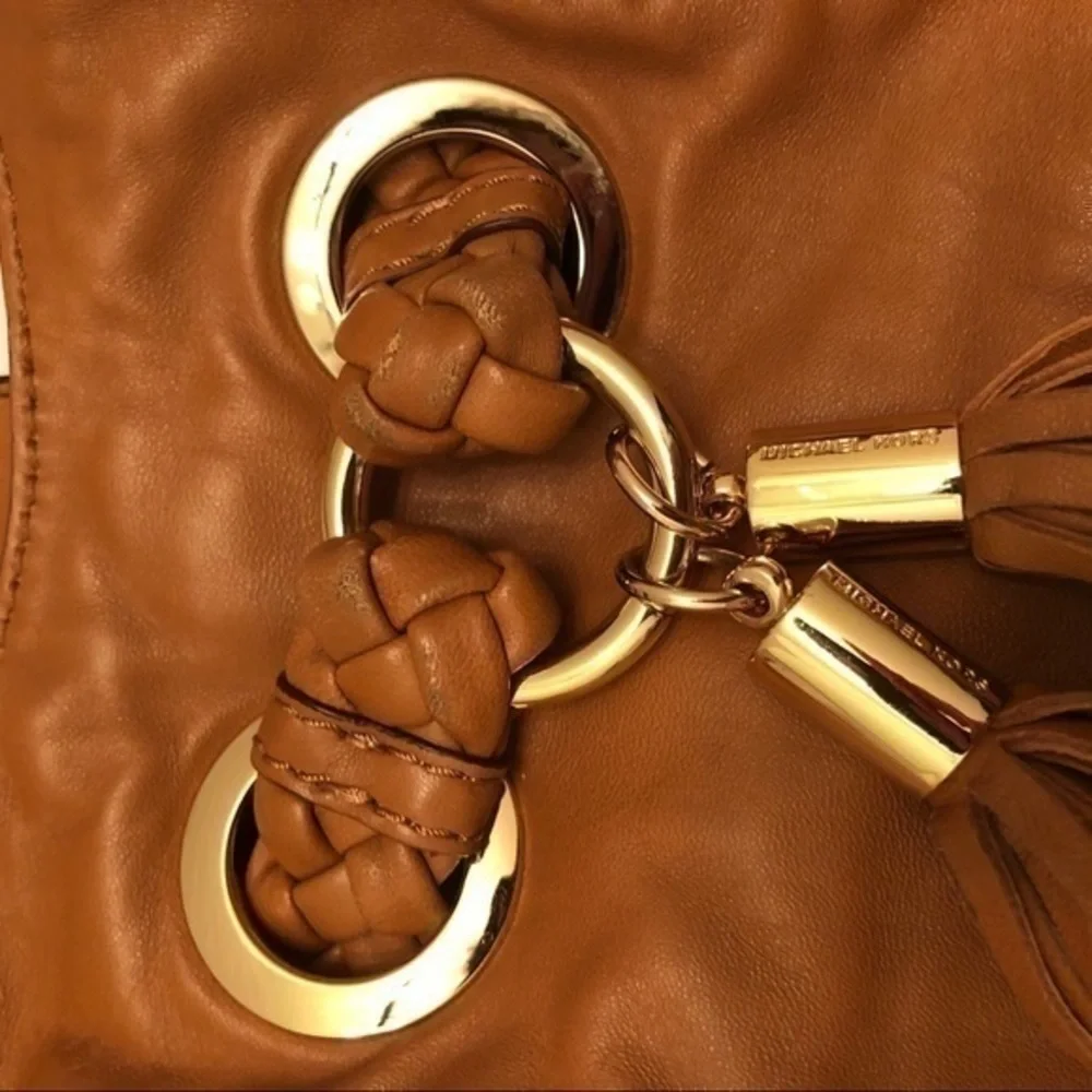 Michael kors brown leather grommet tassel bag